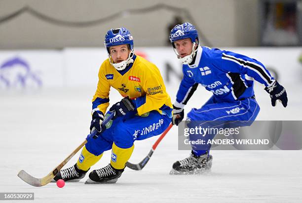 Sweden's Hans Andersson and Finland's Sami Laakkonen vie during Bandy World Championship semifinal match Sweden vs Finland in Vanersborg, Sweden,...