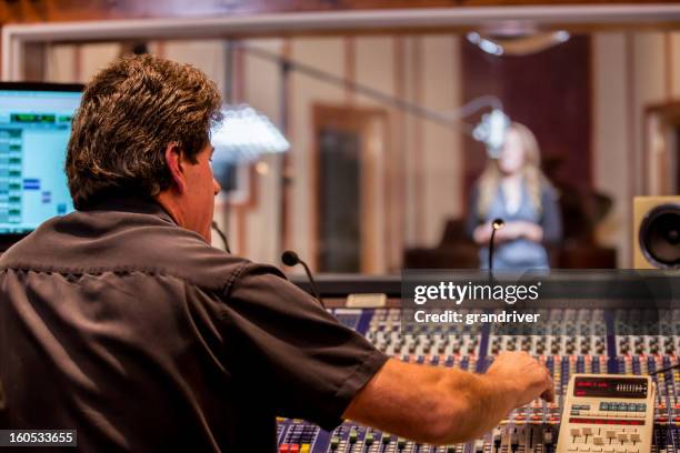 male recording engineer and artist in studio - post production house stock pictures, royalty-free photos & images