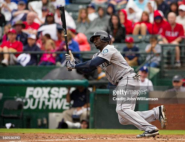 Trayvon Robinson of the Seattle Mariners runs to first base during the game against the Texas Rangers at Rangers Ballpark in Arlington on Sunday,...