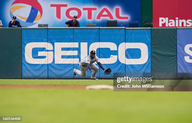 Trayvon Robinson of the Seattle Mariners makes a diving catch during the game against the Texas Rangers at Rangers Ballpark in Arlington on Sunday,...