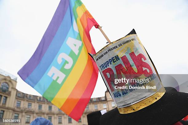 Man waves a flag as he demonstrates during a protest against the Munich Security Conference in the city centre on February 2, 2013 in Munich,...