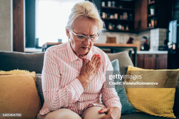 senior woman having heartache. - ischemic heart disease stock pictures, royalty-free photos & images