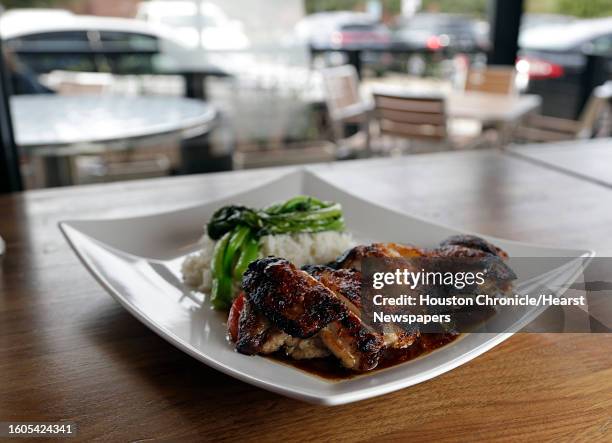 General TsaoÕs Chicken, Crispy skin on chicken leg meat, onion, green onion, carrots, micro greens, steamed rice, eggrolls at Maba Pan-Asian Diner...