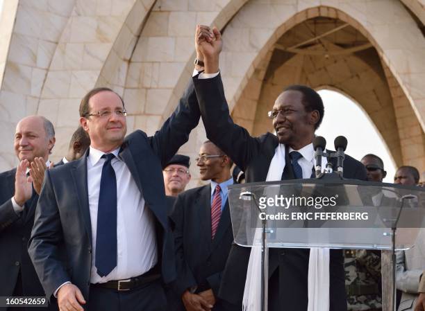French President Francois Hollande and Malian President Dioncounda Traore wave to the crowd after their speech on February 2, 2013 in Bamako....