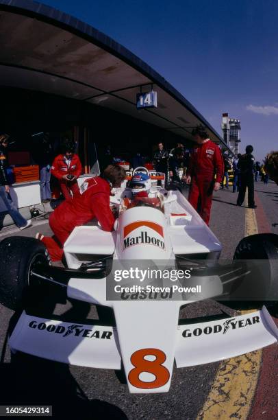 Patrick Tambay from France sits aboard the Marlboro Team McLaren McLaren M28 Ford Cosworth DFV V8 and talks with Team Manager Alastair Caldwell in...