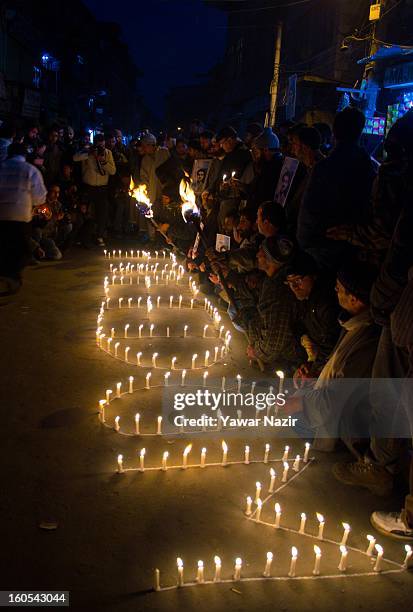 Supporters of the Kashmiri separatist party, the Jammu Kashmir Liberation Front , assemble around an arrangement of candles spelling out 'Freedom'...