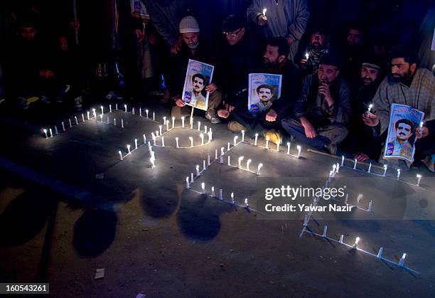 Supporters of the Kashmiri separatist party, the Jammu Kashmir Liberation Front , assemble around an arrangement of candles spelling out 'Freedom'...