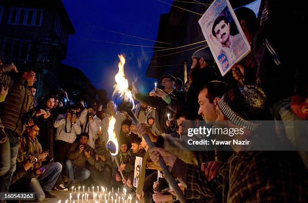 Supporters of the Kashmiri separatist party, the Jammu Kashmir Liberation Front , assemble around an arrangement of candles spelling out 'Freedom'...