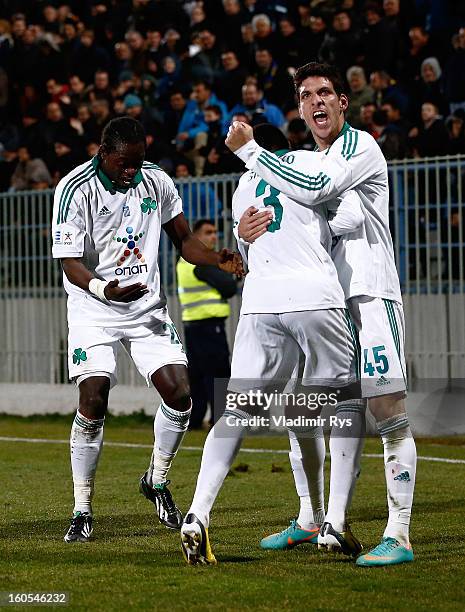 Ibrahim Sissoko is congratulated by his team mates Pape Habib Sow and Konstantinos Triantafyllopoulos of Panathinaikos after scoring his team's...