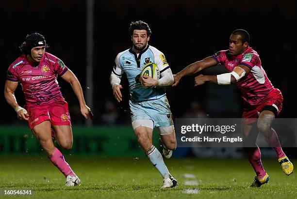 Ben Foden of Northampton outpaces Josh Tatupu and Watisoni Votu of Exeter during the LV= Cup match between Exeter Chiefs and Northampton Saints at...
