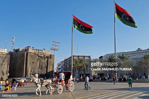 Libyans gather at the Martyrs' Square in Tripoli on August 17, 2023 following recent deadly clashes. A Libyan militia leader whose detention sparked...