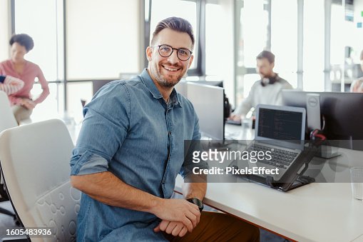 Smiling Freelancer Sitting at Workplace