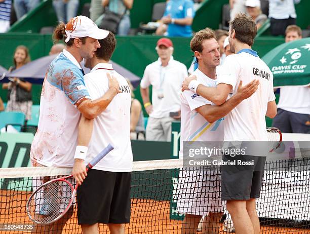 David Nalbandian and Horacio Zeballos of Argentina greet Christopher Kas and Tobias Kamke of Germany after a match on the second day of Davis Cup at...