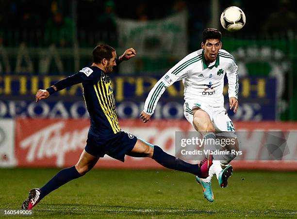 Fernando Usero of Tripolis defends as Konstantinos Triantafyllopoulos of Panathinaikos kicks the ball during the Superleague match between Asteras...