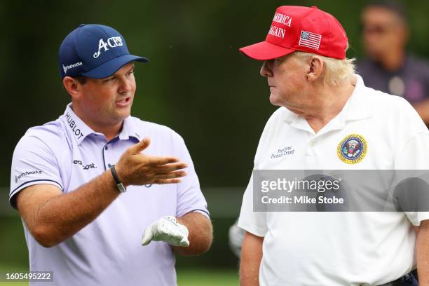 Former President Donald Trump talks with Patrick Reed on the third tee during the pro-am prior to the LIV Golf Invitational - Bedminster at Trump...