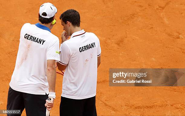 Christopher Kas and Tobias Kamke of Germany talk during the match against David Nalbandian and Horacio Zeballos of Argentina on the second day of...