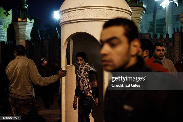 Protesters gather in front of the gates of the Egyptian Presidential Palace during a demonstration following the commemoration march for a protester,...