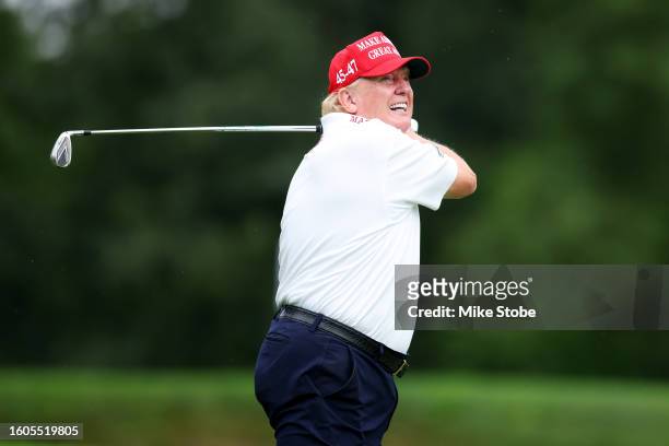 Former President Donald Trump follows his tee shot on the 3rd tee during the pro-am prior to the LIV Golf Invitational - Bedminster at Trump National...