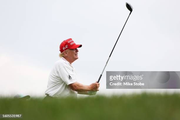 Former President Donald Trump hits his shot from the second tee during the pro-am prior to the LIV Golf Invitational - Bedminster at Trump National...