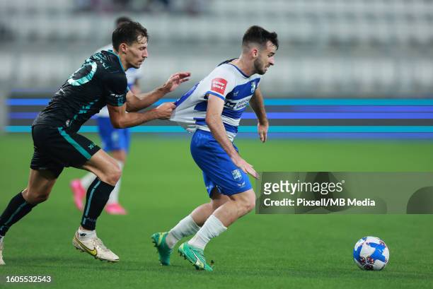 Benjamin Stambouli of Adana Demirspor and Domagoj Bukvic of Osijek in action during the UEFA Europa Conference League 3rd qualifying round second leg...