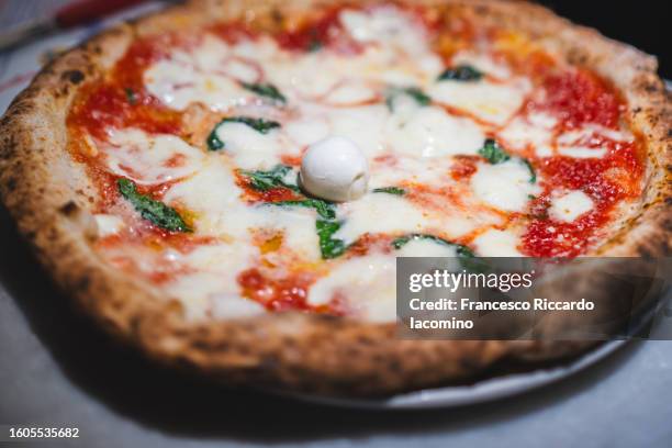 original pizza margherita in a traditional pizzeria, naples, italy. - napoli pizza stock pictures, royalty-free photos & images