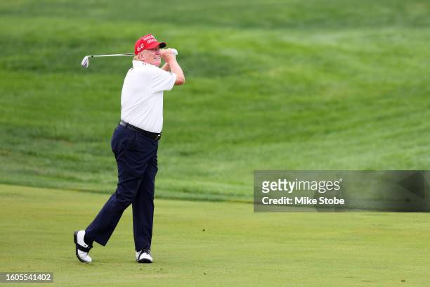 Former President Donald Trump hits his shot from the first fairway during the pro-am prior to the LIV Golf Invitational - Bedminster at Trump...