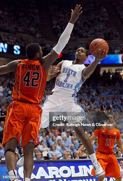 North Carolina's Dexter Strickland drives to the basket against Virginia Tech's C.J. Barksdale during the second half at the Smith Center in Chapel...