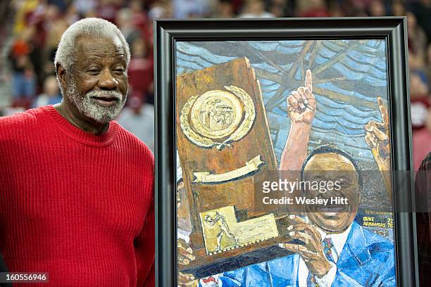 Former Head Coach Nolan Richardson of the Arkansas Razorbacks stands beside his painting to commemorate the 75th anniversary of March Madness during...
