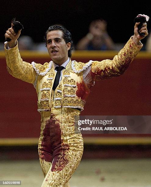 Spanish bullfighter Ivan Fandino celebrates raising the bull's ears after a bullfight at La Macarena bullring on February 2, 2013 in Medellin,...