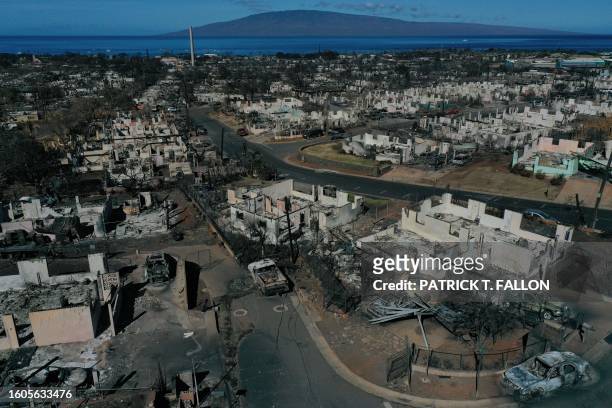 An aerial image shows destroyed homes and vehicles after a wind driven wildfire burned from the hills through neighborhoods to the Pacific Ocean, as...