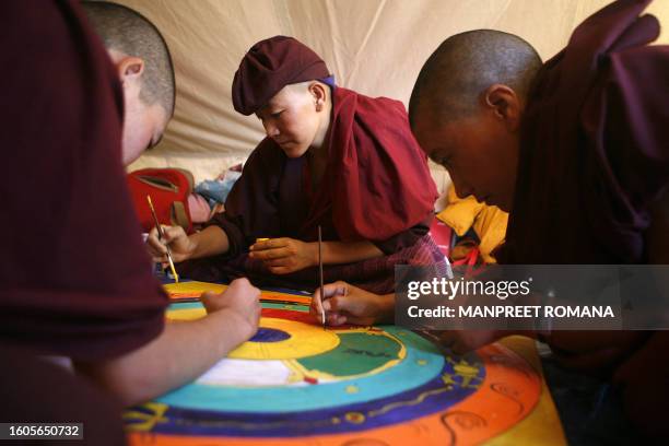 Buddhist nuns make a mandala or traditonal painting in a tent outside The Naro Photang Puspahari temple in Shey, some 15 kilometers south of Leh, 19...