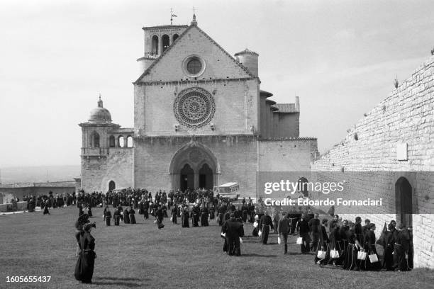 View of Franciscan friars on the lawn in front of the Basilica of San Francesco, Assisi, Italy, September 29, 1976.