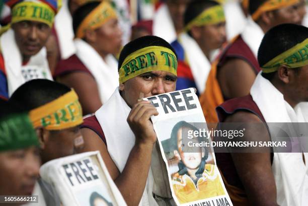 Tibetan Buddhist monks hold posters of the Panchen Lama during a demonstration in Bangalore, 09 March 2007. More than 150 Tibetan monks had...
