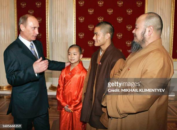 Russian President Vladimir Putin chats with Shaolin Monks during their meeting in the Kremlin as part of the 'Year of China in Russia' in Moscow, 27...