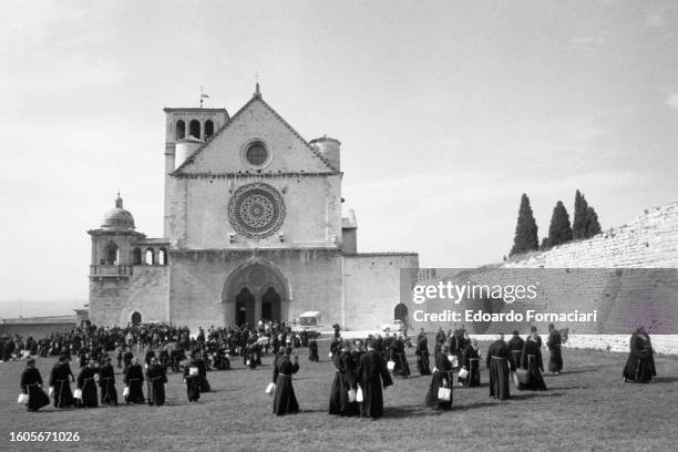 View of Franciscan friars on the lawn in front of the Basilica of San Francesco, Assisi, Italy, September 29, 1976.