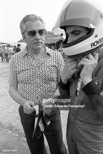 View of Italian SIR owner and president Angelo 'Nino' Rovelli watches as his son, Felice Rovelli, puts on a helmet, Parma, Italy, September 19, 1976....