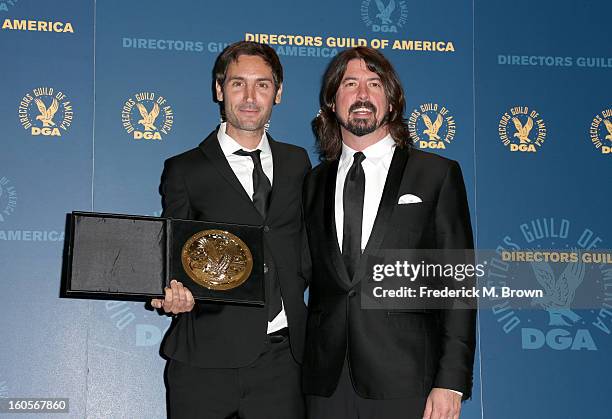 Director Malik Bendjelloul , winner of the Outstanding Directorial Achievement in Documentary for "Searching for Sugar Man," and presenter Davd Grohl...