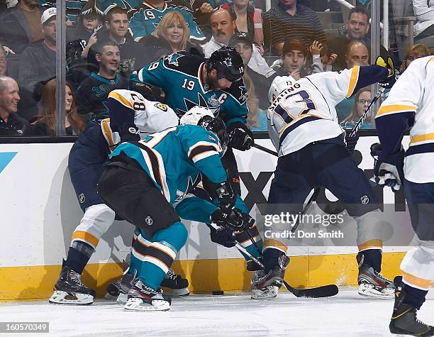 Joe Thornton and Ryane Clowe of the San Jose Sharks battle for the puck against Mike Fisher and Paul Gaustad of the Nashville Predators during an NHL...