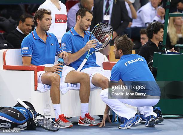 Julien Bennetteau and Michael Llodra of France listen to Arnaud Clement, coach of France during their doubles match against Jonathan Erlich and Dudi...