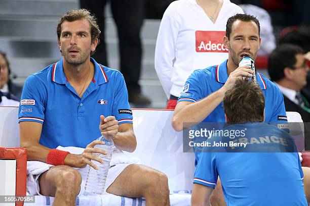 Julien Bennetteau and Michael Llodra of France listen to Arnaud Clement, coach of France during their doubles match against Jonathan Erlich and Dudi...