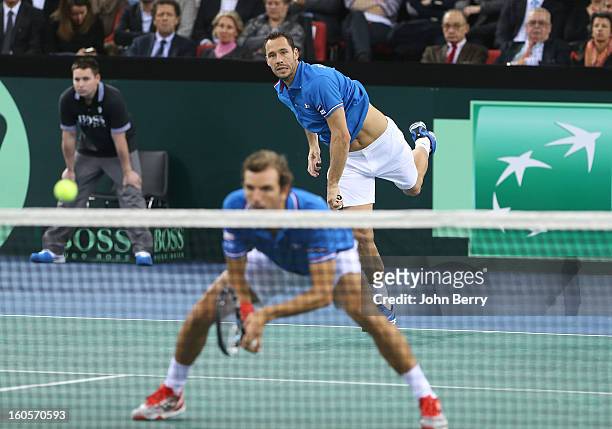 Michael Llodra of France serves during his doubles match with teammate Julien Bennetteau against Jonathan Erlich and Dudi Sela of Israel on day two...