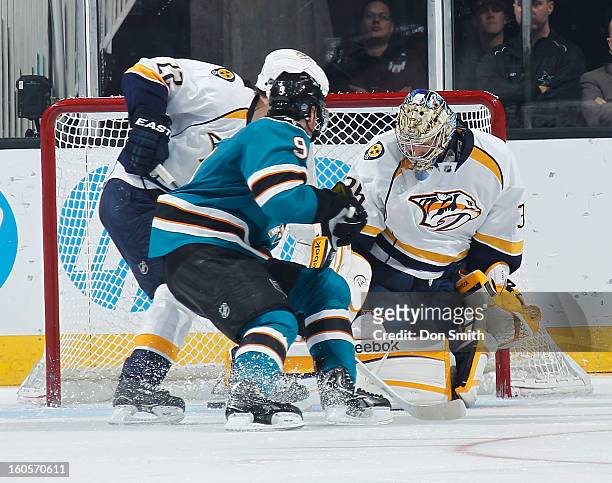 Martin Havlat of the San Jose Sharks tries to score against Pekka Rinne and Scott Hannan of the Nashville Predators during an NHL game on February 2,...