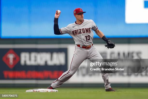 Nick Ahmed of the Arizona Diamondbacks completes a double play in the seventh inning during a game against the Minnesota Twins at Target Field on...