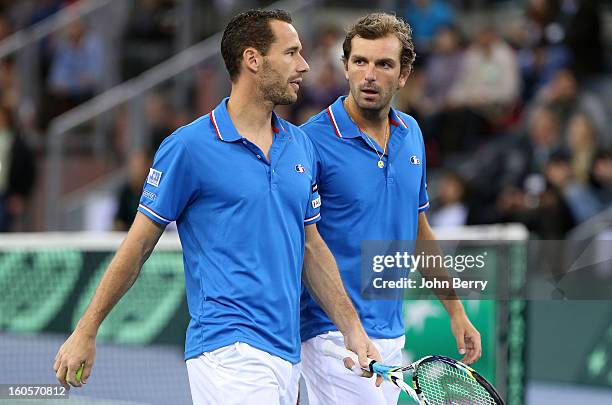 Julien Bennetteau and Michael Llodra of France share tactics during their doubles match against Jonathan Erlich and Dudi Sela of Israel on day two of...