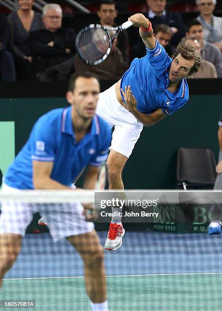 Julien Bennetteau who serves and Michael Llodra of France in action during their doubles match against Jonathan Erlich and Dudi Sela of Israel on day...