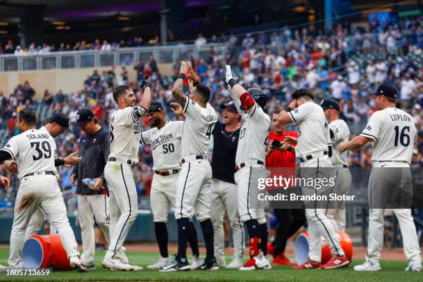 Matt Wallner of the Minnesota Twins celebrates with teammates after hitting a walk-off two-run home run in the ninth inning during a game against the...