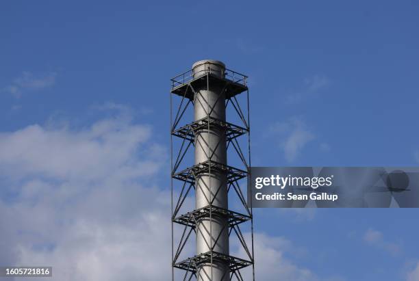 The chimney standss at the Cemex cement factory on August 10, 2023 in Rudersdorf, Germany. Cement production, which requires intense heat in the...