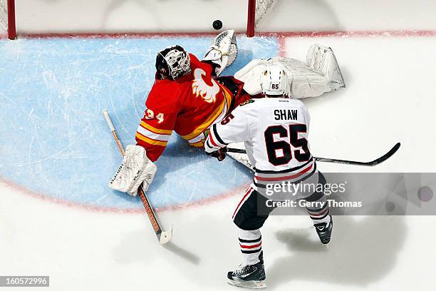 Andrew Shaw of the Chicago Blackhawks watches a puck cross the goal line against Miikka Kiprusoff of the Calgary Flames on February 2, 2013 at the...