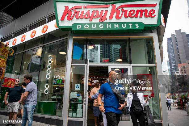 People exit Krispy Kreme store at Times Square on August 10, 2023 in New York City. Krispy Kreme The Charlotte, North Carolina-based company are...