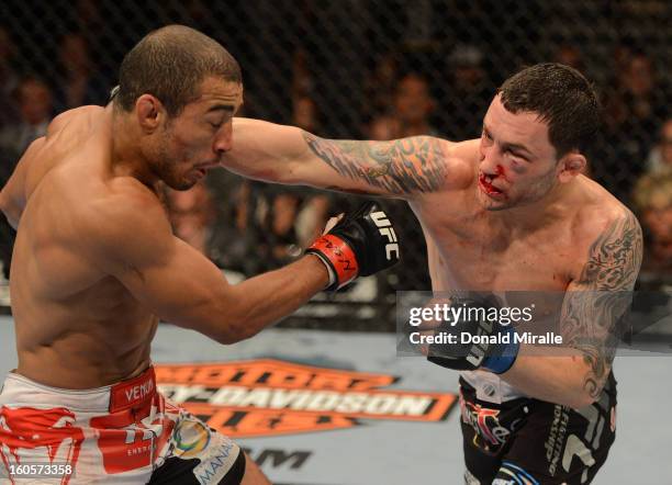 Frankie Edgar punches Jose Aldo during their featherweight title fight at UFC 156 on February 2, 2013 at the Mandalay Bay Events Center in Las Vegas,...